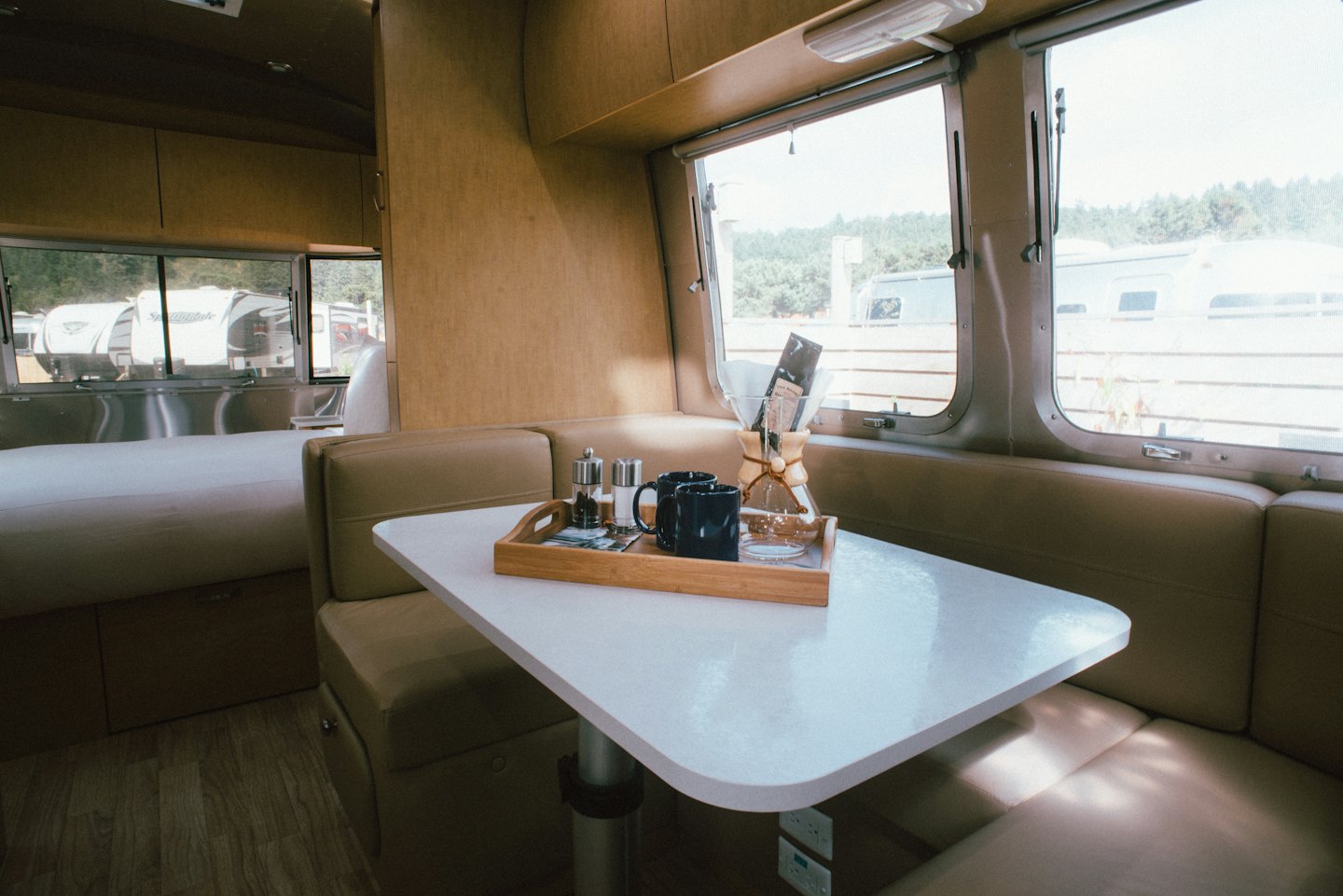 Dining area with coffee setup inside a modern recreational vehicle.